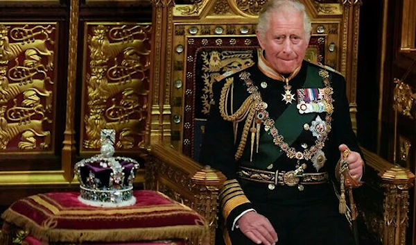 Prince Charles is seated next to the Queen's crown at the Palace of Westminster in London, May 10, 2022 (AP)