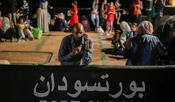 A Sudanese evacuee waits at Port Sudan before boarding a Saudi military ship to Jeddah port, on May 3, 2023 (AP Photo/Amr Nabil, File)