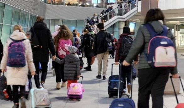 Ukrainians on their way to the United Kingdom, on a stopover at Warsaw airport, March 21, 2022. (AP)