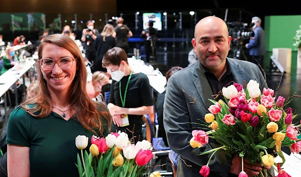 Emily Buning (L), newly elected Greens party Federal Political Director, poses with party politician Omid Nouripour who's been elected as co-party leader, during a Party Congress in Berlin, Germany, Jan. 29, 2022 (Reuters)