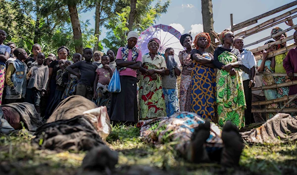 Relatives gather to identify bodies in the village of Nyamukubi, South Kivu province, Congo, Saturday, May 6, 2023. (AP)