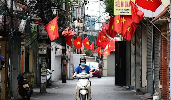 A woman riding a bike in Vietnam (AFP)