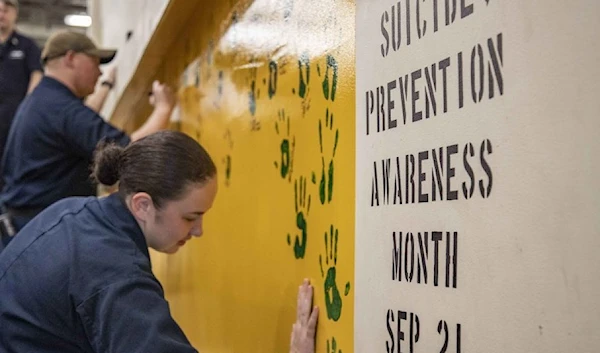 handprint on the bulkhead of the vehicle stowage ramp aboard the amphibious transport dock ship USS Green Bay (LPD 20) in recognition of Suicide Awareness Month. (US Navy)