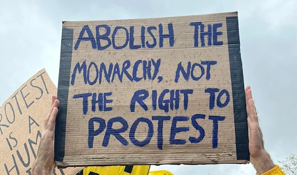 Member of 'Republic' holds a placard that reads out "Abolish the monarchy, not the right to protest" on May 6 after police arrested members of the group during the coronation of King Charles III in London, UK. (@RepublicStaff/Twitter)