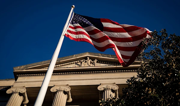 An American flag waves outside the U.S. Department of Justice Building in Washington, U.S., December 15, 2020. (Reuters)