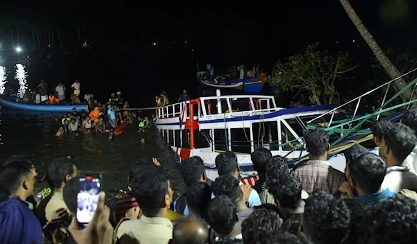 Rescue team members search for survivors after a boat capsized off the coastal town of Tanur in the Malappuram district of the southern state of Kerala, India, on May 7, 2023 (Reuters)