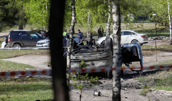 A view shows a damaged white Audi Q7 car lying overturned on a track next to a wood, after Russian nationalist writer Zakhar Prilepin was allegedly wounded in a bomb attack in a village in the Nizhny Novgorod region, Russia, on May 6, 2023 (Reuters)