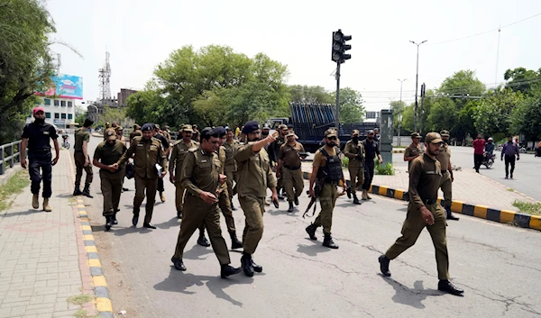 Police officers patrol around the residence of Pakistan's former Prime Minister Imran Khan, in Lahore, Pakistan, Thursday, May 18, 2023 (AP Photo/K.M. Chaudary)