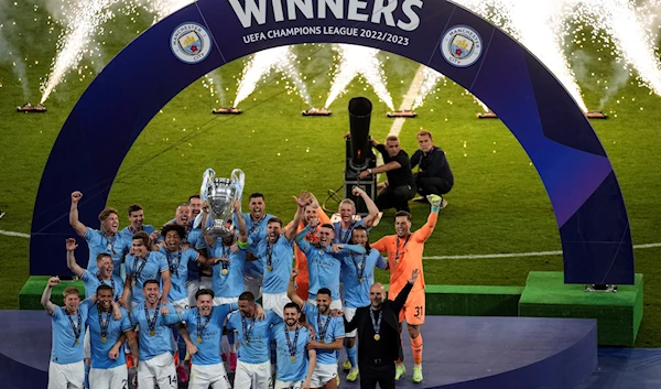 Manchester City team celebrate with the trophy after winning the Champions League final soccer match against Inter Milan at the Ataturk Olympic Stadium in Istanbul, Turkey, June 11, 2023