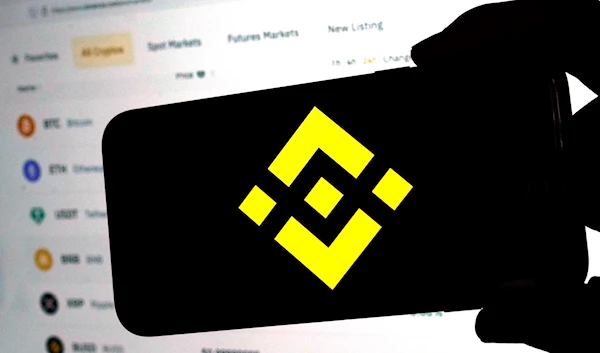 The logo for cryptocurrency site Binance appears on a mobile phone in New York, on January 31, 2023 (AP)