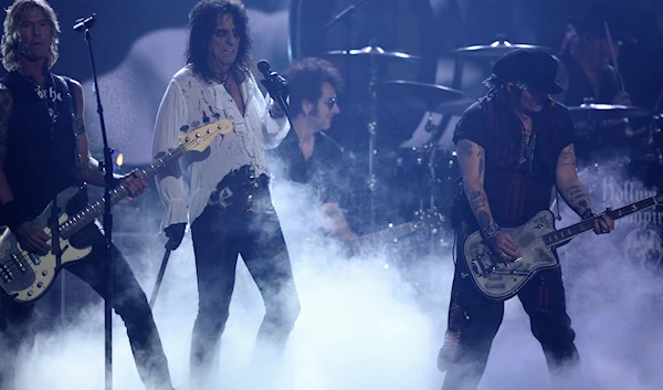 Duff McKagan, left, performs with Alice Cooper and Johnny Depp of Hollywood Vampires at the 58th annual Grammy Awards on Monday, Feb. 15, 2016, in Los Angeles. (AP)