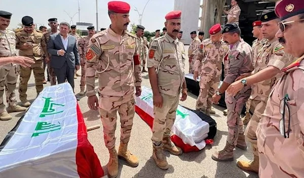 The bodies of Iraqi soldiers at Kirkuk airport in northern Iraq on June 11. (AFP)