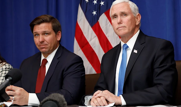 Vice President Mike Pence, right, and Florida Gov. Ron DeSantis take questions during a Florida Coronavirus Response Meeting, at the West Palm Beach International Airport, Friday, Feb. 28, 2020, in West Palm Beach, Fla.