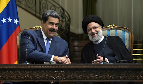 Iranian President Ebrahim Raisi, right, and his Venezuelan counterpart Nicolas Maduro shake hands at the Saadabad Palace in Tehran, Iran on Saturday. Photo: AP