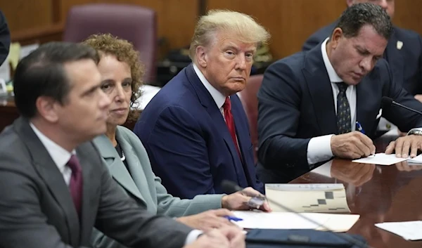 Former President Donald Trump sits at the defense table with his legal team in a Manhattan court, Tuesday, April 4, 2023, in New York (AP)