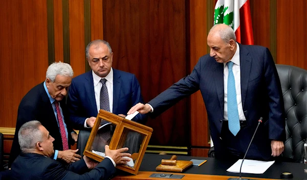 Lebanese Parliament Speaker Nabih Berri, right, casts his vote as parliament gathers to elect a president at the parliament building in downtown Beirut, Lebanon, Wednesday, June 14, 2023 (AP Photo/Hassan Ammar)