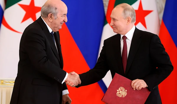 Russian President Vladimir Putin, right, and Algerian President Abdelmadjid Tebboune shake hands during signing ceremony following their talks at the Kremlin in Moscow, Russia, June 15, 2023 (AP)