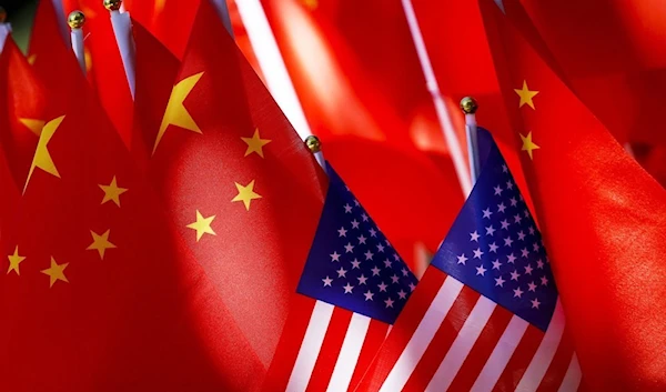 Chinese flags topple two US flags in Beijing, China, November 13 2020. (AP)