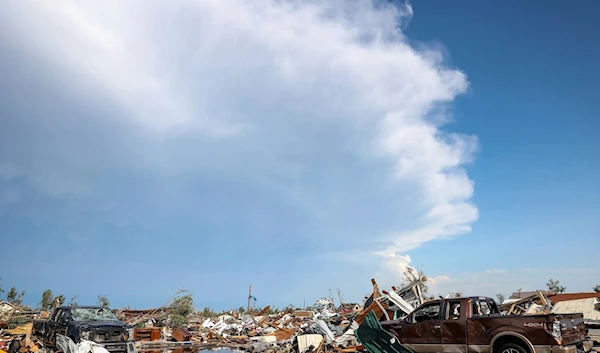 Damaged pickup trucks sit among debris after a tornado passed through a residential area in Perryton, Texas, on Thursday. (AP)