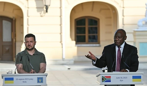 Ukraine's President Volodymyr Zelensky (l) listens on as South Africa's President Cyril Ramaphosa addresses the media in Kyiv on Friday. (AFP)