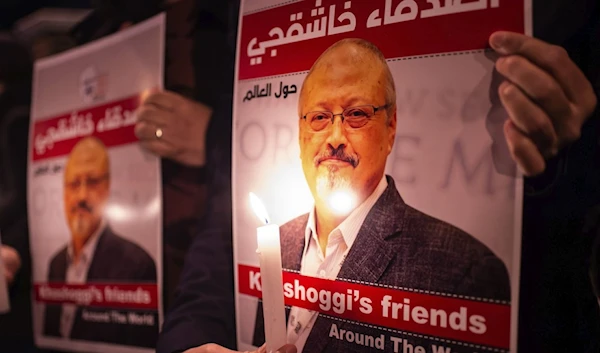 People hold posters of Saudi journalist Jamal Khashoggi and light candles during a gathering outside Saudi Arabia's Consulate in Istanbul, Turkey, Oct. 25, 2018. (AFP)