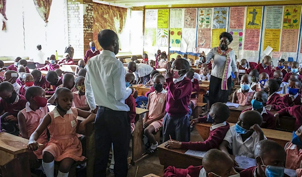 Pupils wear face masks as they attend class at Kitante Primary School in Kampala, Uganda Monday, Jan. 10, 2022. Uganda's schools reopened to students on Monday, ending the world's longest school disruption due to the COVID-19 pandemic. (AP)