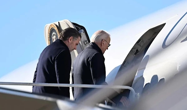 US President Joe Biden boards with his son Hunter Air Force One as he departs from Delaware Air National Guard base in New Castle Delaware on February 4, 2023. (AFP)