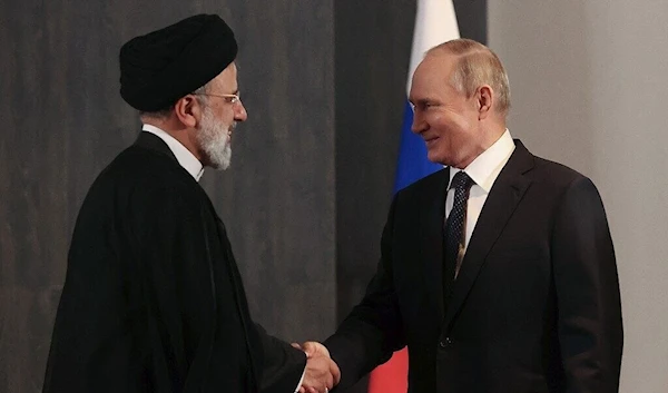 Russian President Vladimir Putin meets with his Iranian counterpart Ebrahim Raisi on the sidelines of the Shanghai Cooperation Organisation (SCO) leaders' summit in Samarkand on September 15, 2022 (AFP)