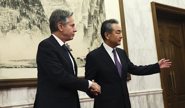 U.S. Secretary of State Antony Blinken, left, shakes hands with China’s top diplomat Wang Yi, right, at the Diaoyutai State Guesthouse in Beijing on June 19, 2023 (AP)