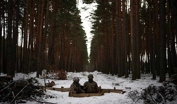 Ukrainian servicemen stand at a position close to the border with Belarus, Ukraine, Wednesday, Feb. 1, 2023 (AP Photo/Daniel Cole)