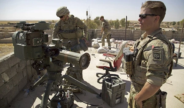 In this Aug. 20, 2017 file photo, U.S. Army soldiers stands next to a guided-missile launcher, a few miles from the frontline, in the village of Abu Ghaddur, east of Tal Afar, Iraq. (AFP)