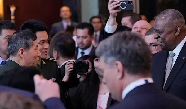 Austin and Chinese counterpart shake hands at Singapore summit