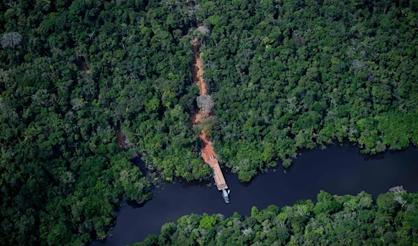 An aerial view showing an illegal dock by a river to remove wood from the Amazon rainforest seen during a flight between Manaus and Manicore, in Amazonas State, Brazil, June 6, 2022 (AFP)