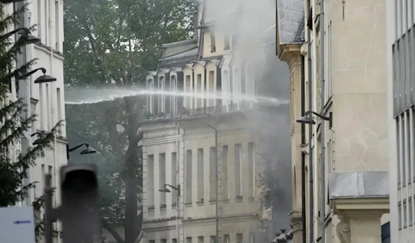 Firemen use a water canon as they fight a blaze Wednesday, June 21, 2023 in Paris. (AP)