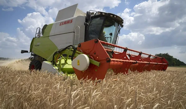 A farmer collects harvest on his field ten kilometres from the front line in the Dnipropetrovsk region, Ukraine, on July 4, 2022. (AP)