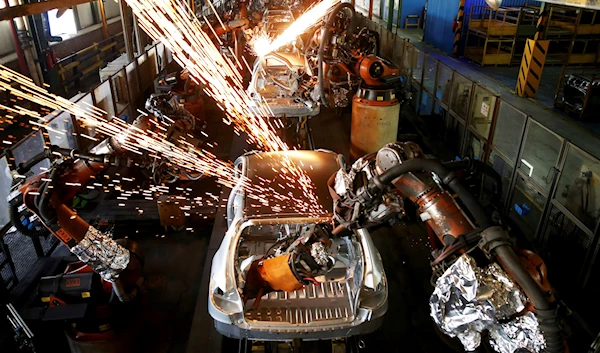 In this Sunday, Sept. 9, 2018 photo, bodies of cars gothrough an assembly line at the Iran Khodro automobile manufacturing plant, just outside Tehran, Iran (AP Photo/Ebrahim Noroozi)