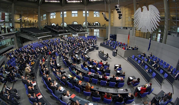 German Chancellor Olaf Scholz delivers a speech during a meeting of the German federal parliament, Bundestag, at the Reichstag building in Berlin, Germany, Dec. 15, 2021. (AP)