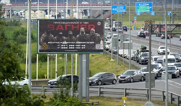 A billboard reading "Join us at Wagner", which is associated with the Wagner private military group and contractor Yevgeny Prigozhin, is seen above a highway on the outskirts of St. Petersburg, Russia, Saturday, June 24, 2023. (AP)