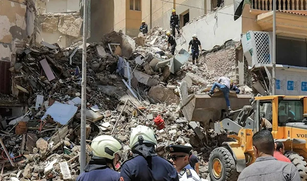 Rescue workers at a collapsed building in the Sidi Bishr district of Alexandria, Egypt, on Monday. (AFP)