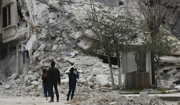 People stans by a building destroyed in recent earthquake in Aleppo, Syria, Monday, Feb. 27, 2023. (AP)