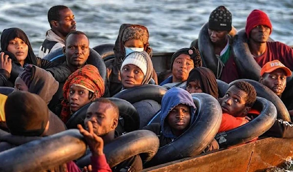 Migrants from sub-Saharan Africa sit in a makeshift boat that was being used to clandestinely make its way towards the Italian coast. (AFP)