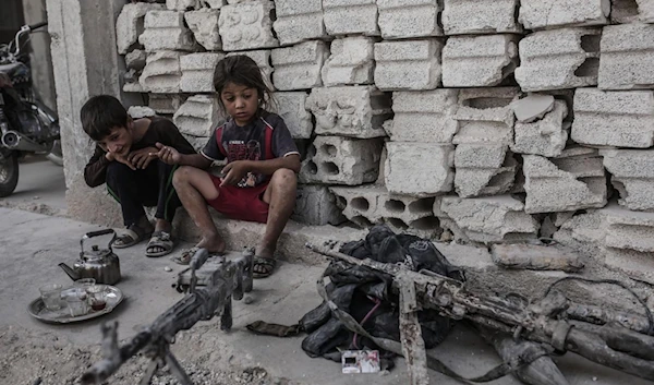 Children look at seized weapons on September 6, 2015 in Kobane, northern Syria (AFP)