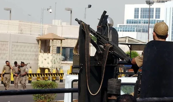 Saudi special forces gather outside the US consulate in Jeddah in 2004, after an attack on the building (AP)