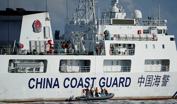 A Chinese Coast Guard ship with bow number 5201 deploys its crew on motor boats to monitor activities from two Philippine Coast Guard vessels near the Second Thomas Shoal locally known as Ayungin Shoal at the South China Sea on Sunday, April 23, 2023. (AP)