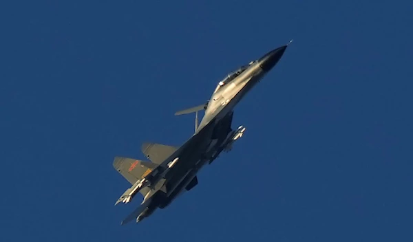 A Chinese J-11 military fighter jet flies above the Taiwan Strait near Pingtan, the closest land of mainland China to the island of Taiwan, in southeastern China's Fujian Province on Aug. 5, 2022 (AP Photo/Ng Han Guan, File)