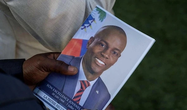 A person holds a photo of late Haitian President Jovenel Moise, who was shot dead, during his funeral at his family home in Cap-Haitien, Haiti, July 23, 2021. ( Reuters)