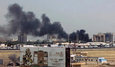 Heavy smoke bellows above buildings in the vicinity of the Khartoum's airport on April 15, 2023, amid clashes in the Sudanese capital. (AFP)