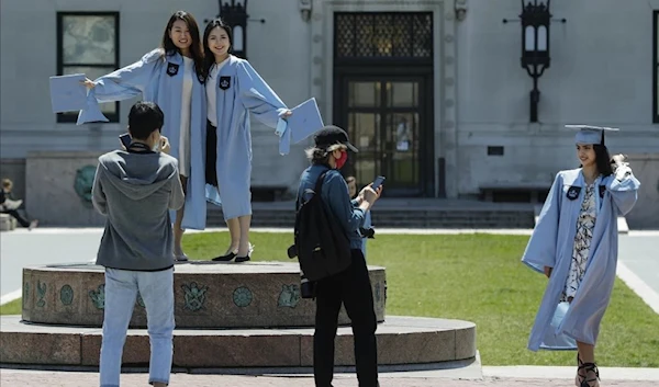 Columbia University class of 2020 graduates pose for photographs on Commencement Day on Wednesday, May 20, 2020, in New York. After three years, the pandemic-era freeze on student loan payments will end in late August. (AP)