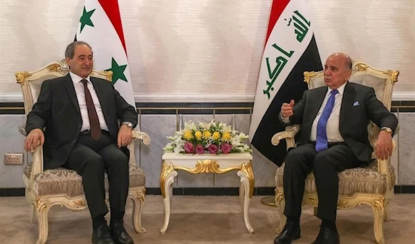 raqi Foreign Minister Fuad Hussein (R) receives his Syrian counterpart Faisal Mekdad in Baghdad on June 4, 2023. (AFP)