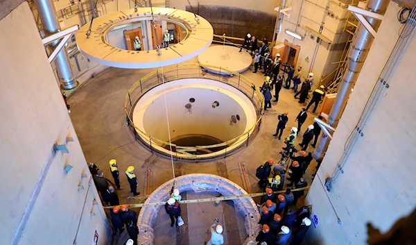 In this photo released by the Atomic Energy Organization of Iran, technicians work at the Arak heavy water reactor's secondary circuit, as officials and media visit the site, near Arak, Iran, December 23, 2019 (AP)